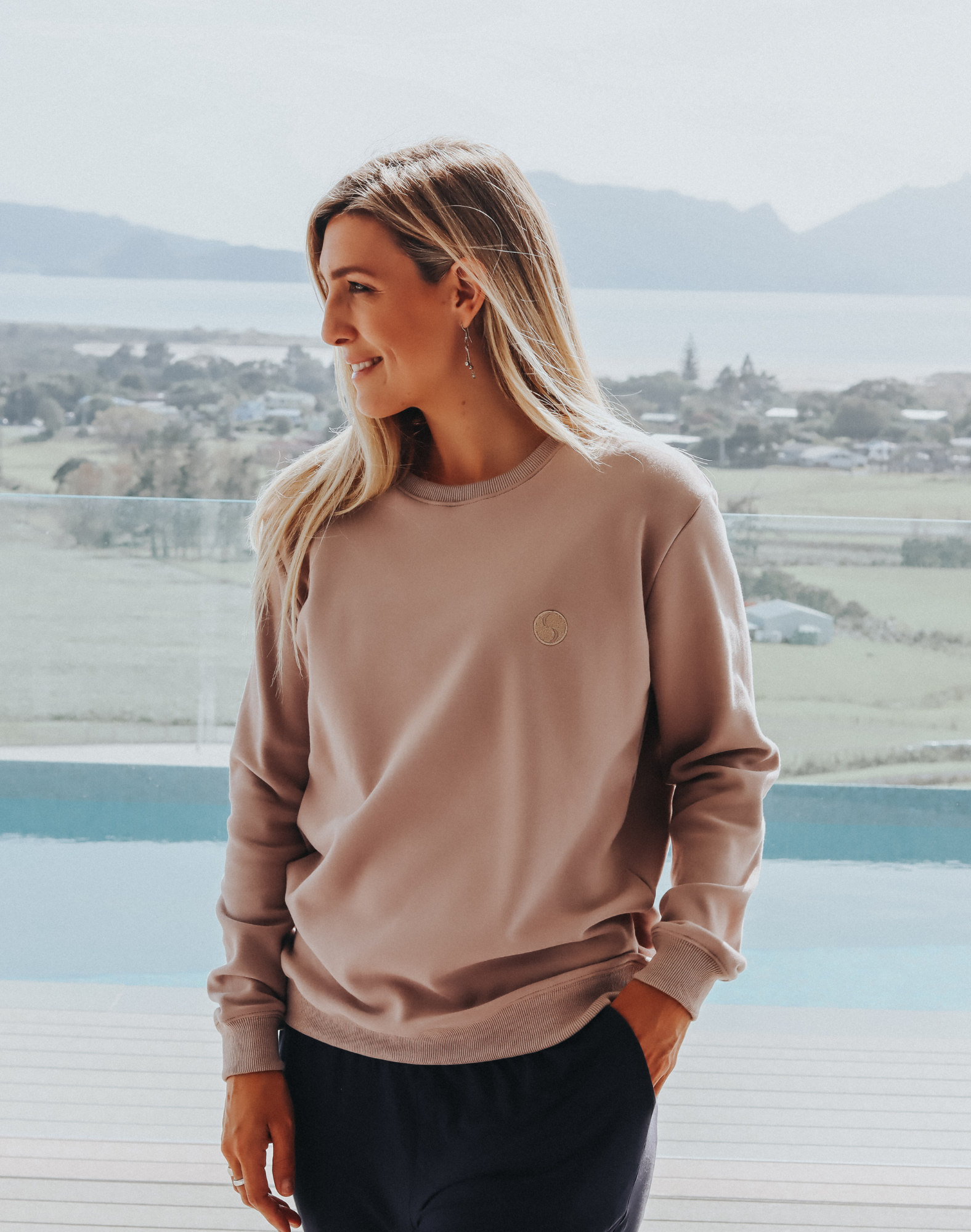 Active mother wearing matching grey women's crew sweatshirt